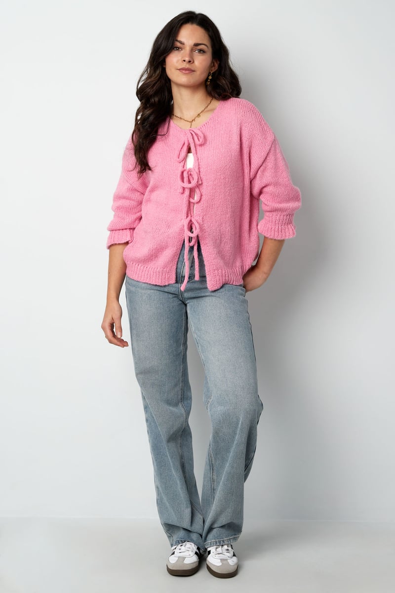 Model posing in the pink Aria Vest Sorea Fashion.