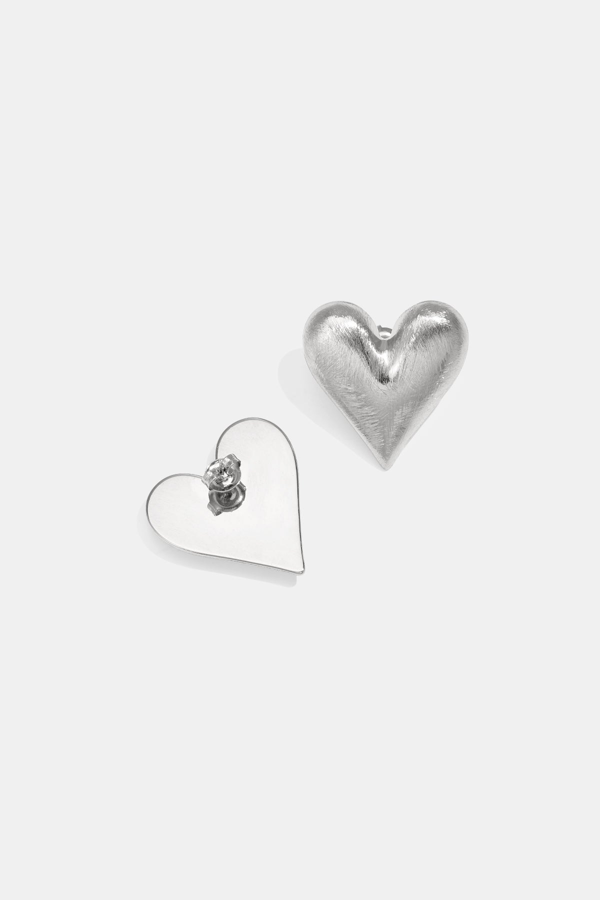 Silver Lia heart-shaped stud earrings displayed on a white background from Sorea Fashion.
