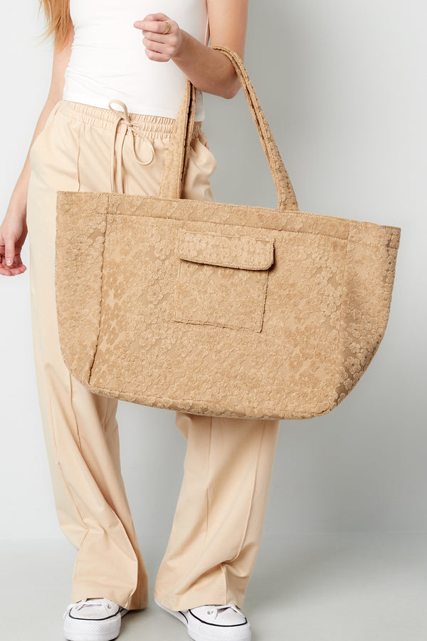 Beige Blossom bag with a woven textured design styled in a casual outfit from Sorea Fashion.