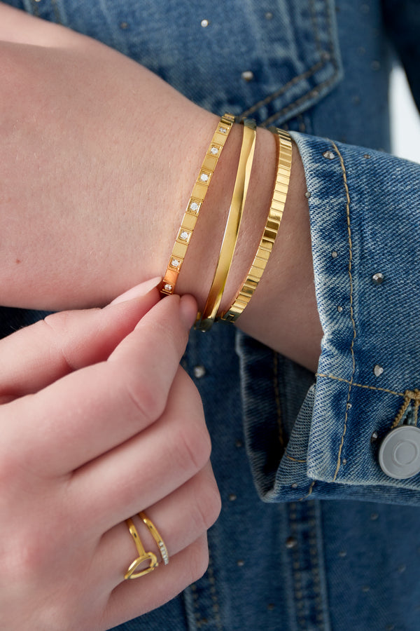 Gold hammered wide cuff bracelet worn on the wrist, Elara bracelet from Sorea Fashion.