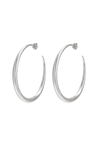 Silver Elena oval hoop earrings with a thick polished shape displayed on a white background from Sorea Fashion.