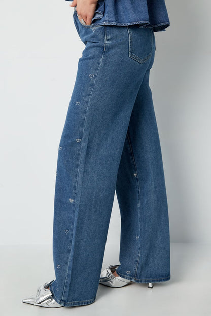 Model styled in the embellished Elys Jeans Sorea Fashion paired with a casual top.