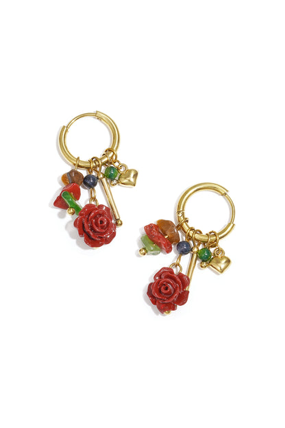 Gold Faye earrings with red gemstone drops displayed on a white background from Sorea Fashion.