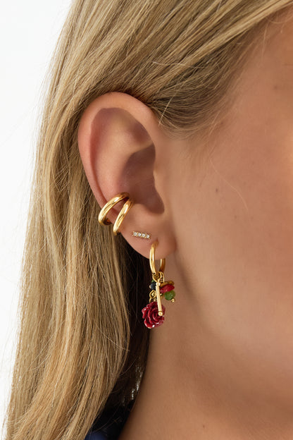 Gold Faye earrings featuring red gemstone drops worn in the ear from Sorea Fashion.
