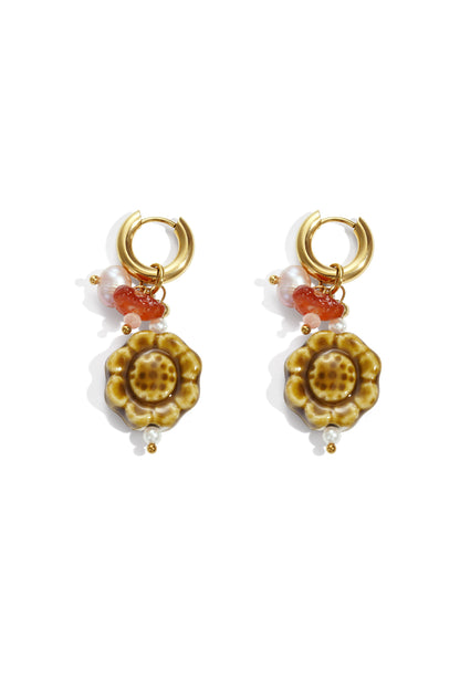 Gold floral stud earrings displayed on a white background, Flora earrings from Sorea Fashion.