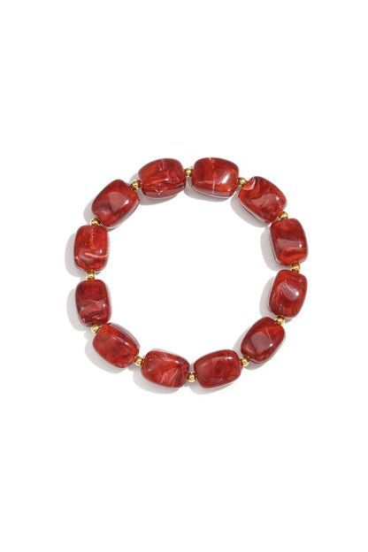 Red Kaia bracelet with polished round beads shown on a white background from Sorea Fashion.