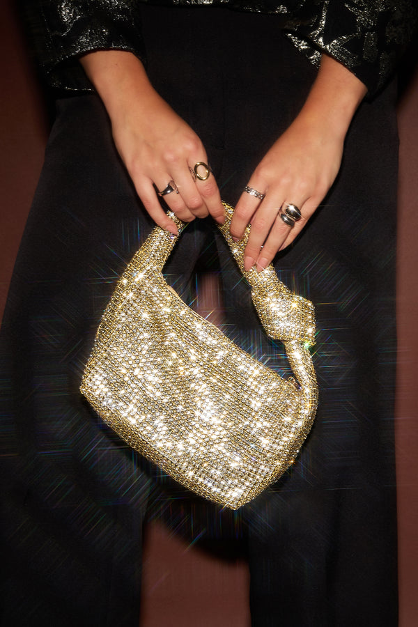 Gold Mea handbag with a structured design worn in a modern outfit from Sorea Fashion.