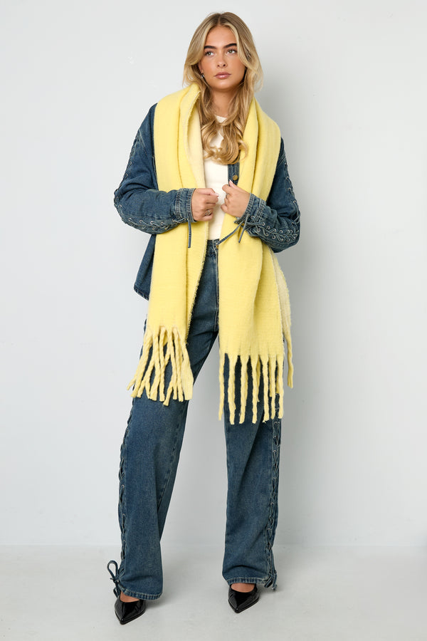 Yellow Nella scarf styled with a casual outfit, featuring soft fringed edges, from Sorea Fashion.