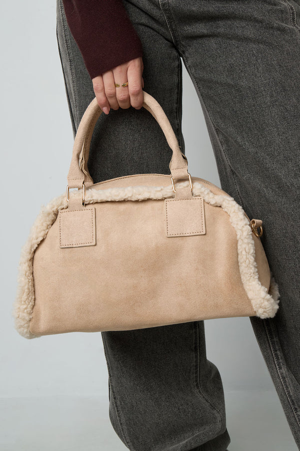 Beige minimalist shoulder bag with soft rounded shape featured in a styled outfit, Tilly by Sorea Fashion.
