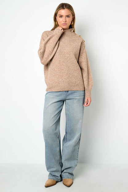 Model posed wearing the soft knit Zoé Sweater Sorea Fashion.